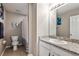 Standard bathroom with white fixtures, granite countertops, tile flooring, and shower at 2636 Scoter Ln, Castle Rock, CO 80104
