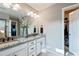 Bright bathroom features a double vanity, granite countertop, and a walk-in closet at 2636 Scoter Ln, Castle Rock, CO 80104