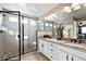 Modern bathroom with granite countertops, double sinks, stylish tile and a glass-enclosed shower at 2636 Scoter Ln, Castle Rock, CO 80104