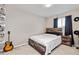 Cozy bedroom features rustic wood bed frame, a window, and decorative shelving at 2636 Scoter Ln, Castle Rock, CO 80104