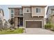 Charming two-story home featuring stone accents, a well-maintained lawn, and an attached two-car garage at 2636 Scoter Ln, Castle Rock, CO 80104
