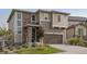 Charming two-story home with stone accents, an attached garage, and professionally landscaped front yard at 2636 Scoter Ln, Castle Rock, CO 80104