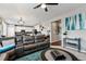 Open-concept living area showcasing a comfortable sectional sofa and a view into the modern kitchen at 2636 Scoter Ln, Castle Rock, CO 80104
