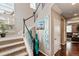 A staircase with carpeted steps leads to an upper level, with decoratively adorned walls and dark wood floors at 2636 Scoter Ln, Castle Rock, CO 80104