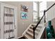 Bright foyer featuring a staircase with carpeted steps, a white banister, and decoratively adorned walls at 2636 Scoter Ln, Castle Rock, CO 80104