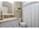 Bathroom featuring a white vanity with granite countertop, mirror, and a shower with a white curtain at 19616 E Pinewood Dr, Aurora, CO 80016