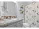 Bathroom featuring a white vanity with a gray countertop and a shower with a patterned curtain at 19616 E Pinewood Dr, Aurora, CO 80016