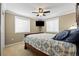 Bedroom featuring a bed in front of windows and carpeted floors at 19616 E Pinewood Dr, Aurora, CO 80016