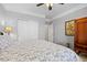 Bedroom featuring a light-colored carpet, wardrobe, ceiling fan, and a queen-sized bed at 19616 E Pinewood Dr, Aurora, CO 80016
