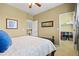 Comfortable bedroom features a ceiling fan, artwork, and an adjoining walk-in closet at 19616 E Pinewood Dr, Aurora, CO 80016