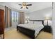 Cozy bedroom with neutral carpet, ceiling fan, and a large window with neutral curtains at 19616 E Pinewood Dr, Aurora, CO 80016