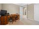 Bedroom features a wooden desk with a chair and carpeted floors at 19616 E Pinewood Dr, Aurora, CO 80016