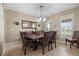 Formal dining room showcasing a large table, chandelier, and beautiful natural lighting at 19616 E Pinewood Dr, Aurora, CO 80016