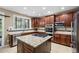 Gourmet kitchen with granite island, stainless steel appliances, and rich wood cabinetry at 19616 E Pinewood Dr, Aurora, CO 80016