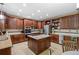 Spacious kitchen featuring custom cabinets, granite countertops, stainless appliances, and a central island at 19616 E Pinewood Dr, Aurora, CO 80016