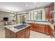 Well-equipped kitchen featuring a granite island, stainless steel appliances, and warm wood cabinets at 19616 E Pinewood Dr, Aurora, CO 80016