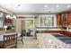 Gourmet kitchen with granite island, stainless steel appliances, and access to the backyard at 19616 E Pinewood Dr, Aurora, CO 80016
