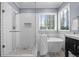 Bright bathroom featuring a walk-in shower and freestanding tub under a large window with blinds at 19616 E Pinewood Dr, Aurora, CO 80016