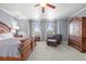 Large main bedroom featuring a seating area with brown leather armchair and ottoman with a ceiling fan at 19616 E Pinewood Dr, Aurora, CO 80016
