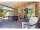 Relaxing covered patio featuring a hot tub and sliding glass door at 19616 E Pinewood Dr, Aurora, CO 80016