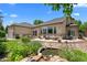 Expansive backyard with a stone patio, outdoor dining, and a tranquil pond creating a private oasis at 222 S Olive St, Denver, CO 80230