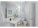 Stylish bathroom features a pedestal sink, tile floors, and updated fixtures at 222 S Olive St, Denver, CO 80230