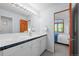 Bathroom featuring double sinks and view into the bedroom at 222 S Olive St, Denver, CO 80230