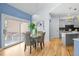 Bright dining area with modern light fixture, patio door, and adjacent to a gray kitchen at 222 S Olive St, Denver, CO 80230