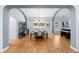 Open-concept dining room featuring an elegant chandelier and hardwood floors at 222 S Olive St, Denver, CO 80230