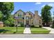Inviting two-story home with lush landscaping and a classic brick facade at 222 S Olive St, Denver, CO 80230
