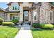 Close-up of the home's entry with lovely landscaping and beautiful door at 222 S Olive St, Denver, CO 80230