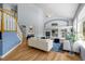 Bright living room showcasing high ceilings, fireplace, and a staircase with white railing at 222 S Olive St, Denver, CO 80230
