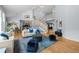 Bright living room featuring an open floor plan, a staircase, and comfortable seating at 222 S Olive St, Denver, CO 80230