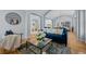 Bright living room with hardwood floors, arched doorways and a comfortable blue velvet sofa at 222 S Olive St, Denver, CO 80230