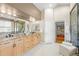 Luxury main bathroom features double sinks, granite counters, and glass shower at 222 S Olive St, Denver, CO 80230