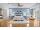Spacious main bedroom features hardwood floors, a ceiling fan, and abundant natural light at 222 S Olive St, Denver, CO 80230