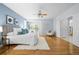 Bright main bedroom featuring hardwood floors and a door to the bathroom at 222 S Olive St, Denver, CO 80230