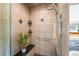 Tiled shower with bench, handheld shower head, and accent tiles at 222 S Olive St, Denver, CO 80230