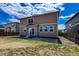 Rear exterior view featuring siding, windows, and a patio in a suburban backyard setting at 2325 Mountain Sky Dr, Fort Lupton, CO 80621