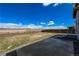 Expansive backyard featuring a concrete patio and a wooden fence with open views at 2325 Mountain Sky Dr, Fort Lupton, CO 80621