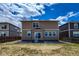 This home's backyard has a concrete patio and sliding glass door at 2325 Mountain Sky Dr, Fort Lupton, CO 80621