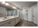 Bathroom featuring double sinks, large mirror, and a modern walk-in shower at 2325 Mountain Sky Dr, Fort Lupton, CO 80621
