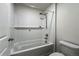 Elegant bathroom with a shower over tub, white tiled walls, and neutral accents at 2325 Mountain Sky Dr, Fort Lupton, CO 80621