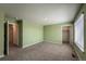 Spacious bedroom featuring neutral carpet, large windows, and multiple doorways at 2325 Mountain Sky Dr, Fort Lupton, CO 80621