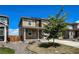 Charming two-story home with a well-manicured lawn, complemented by a cozy front porch at 2325 Mountain Sky Dr, Fort Lupton, CO 80621