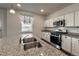 Modern kitchen featuring an island, stainless steel appliances, and granite countertops at 2325 Mountain Sky Dr, Fort Lupton, CO 80621