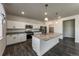 Modern kitchen featuring an island, stainless steel appliances, granite countertops, and white cabinetry at 2325 Mountain Sky Dr, Fort Lupton, CO 80621