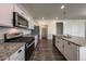 Kitchen featuring stainless steel appliances, granite countertops, and white cabinetry at 2325 Mountain Sky Dr, Fort Lupton, CO 80621