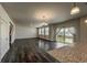 Open concept living room showcasing hardwood floors, kitchen island, and natural light from windows at 2325 Mountain Sky Dr, Fort Lupton, CO 80621