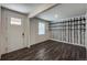 Inviting living room area with hardwood floors, unique décor, and natural light from the front door window at 2325 Mountain Sky Dr, Fort Lupton, CO 80621